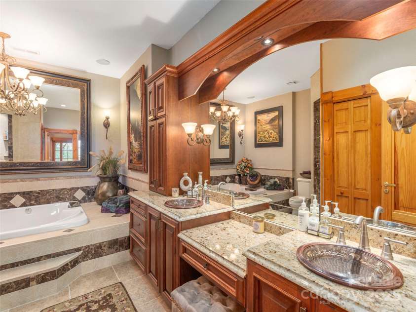 574 Leatherwood Drive, Maggie Valley, NC 28751.  MLS# CAR4275910, YatesRealty ID 23479. Lower primary suite's large, custom bathroom
