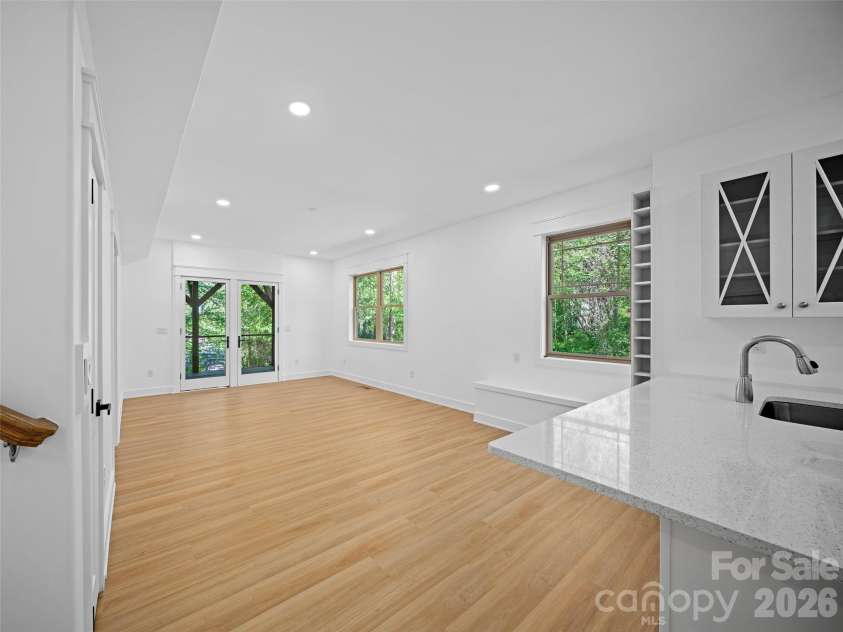 92 Cedar Street, Asheville, NC 28803.  MLS# CAR4377479, YatesRealty ID 23482. Lower level great room with living dining kitchen space, and exit to back yard