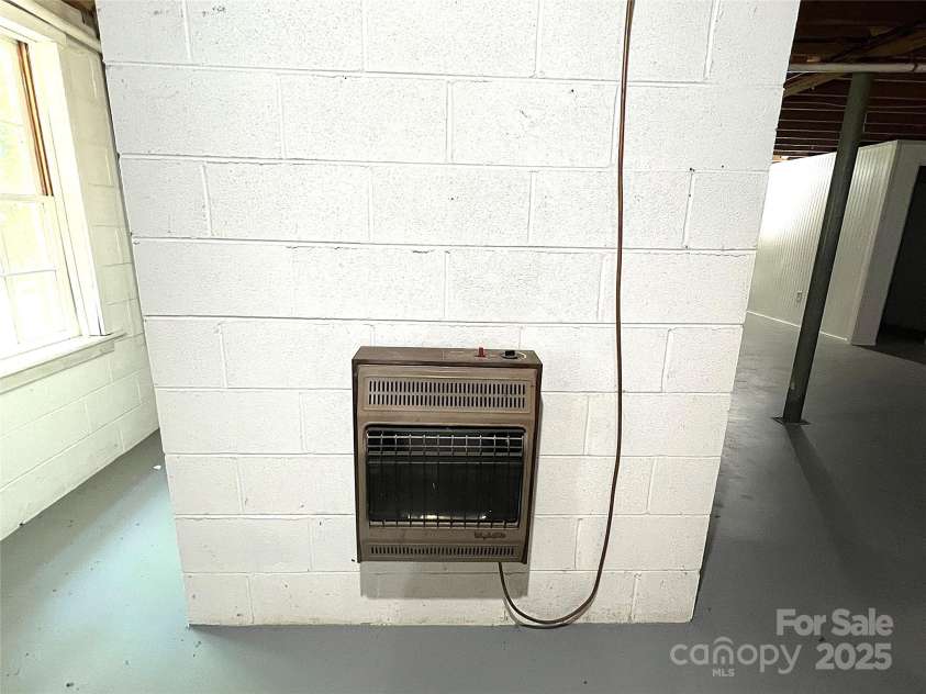 341 Rugby Road, Hendersonville, NC 28791.  MLS# CAR4271870, YatesRealty ID 23501. Wall-Mounted Gas Heater in Basement