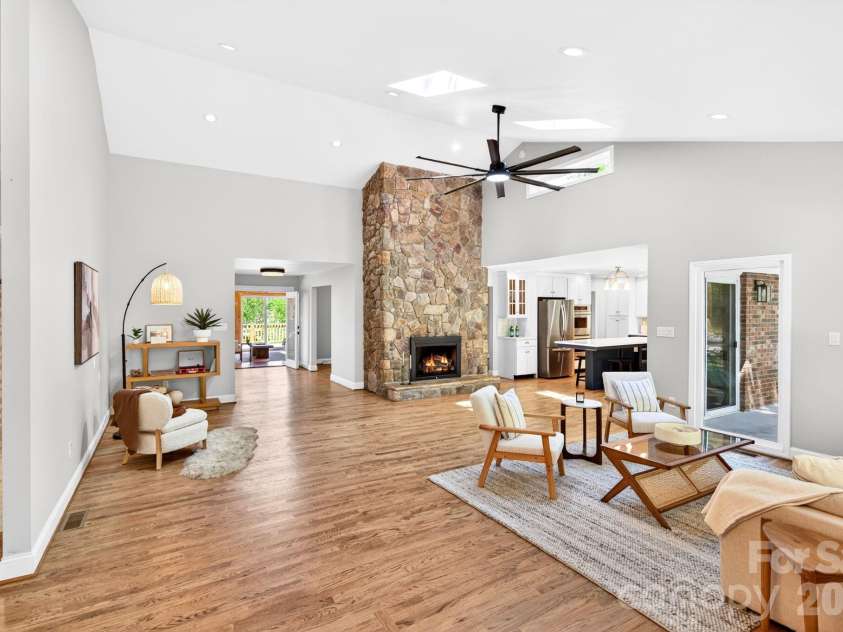 58 Camby Drive, Fairview, NC 28730.  MLS# CAR4371628, YatesRealty ID 23505. Great Room with Stone Fireplace and Skylights