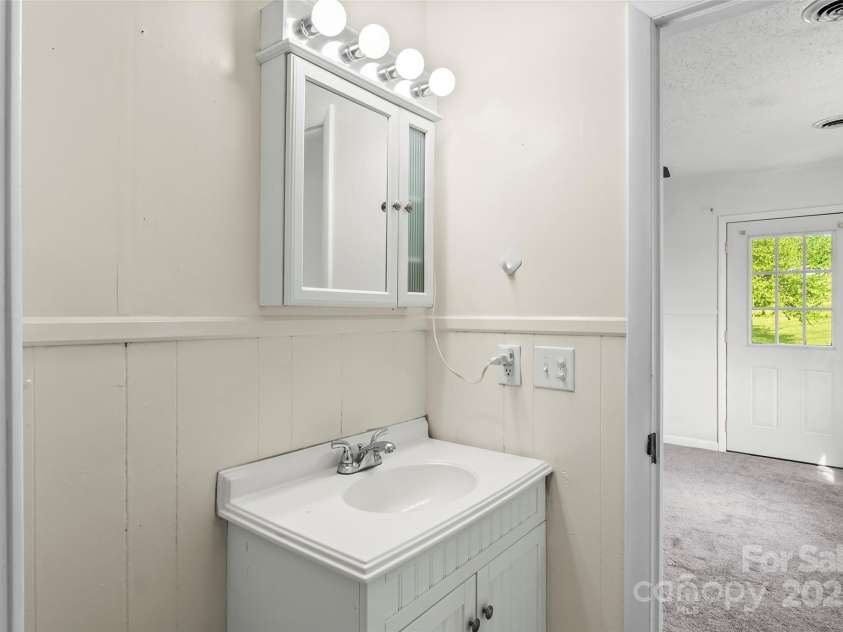 493 Dogwood Road, Candler, NC 28715.  MLS# CAR4257818, YatesRealty ID 23510. Primary Bathroom (new vanity since photo)