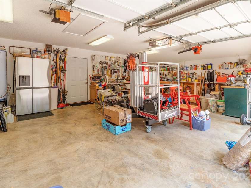 65 Hillcrest Drive, Weaverville, NC 28787.  MLS# CAR4275915, YatesRealty ID 23514. Big garage with workshop area and access to back patio