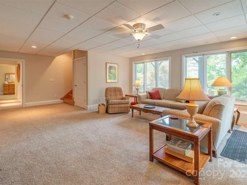 65 Hillcrest Drive, Weaverville, NC 28787.  MLS# CAR4275915, YatesRealty ID 23514. Family room lower level with 