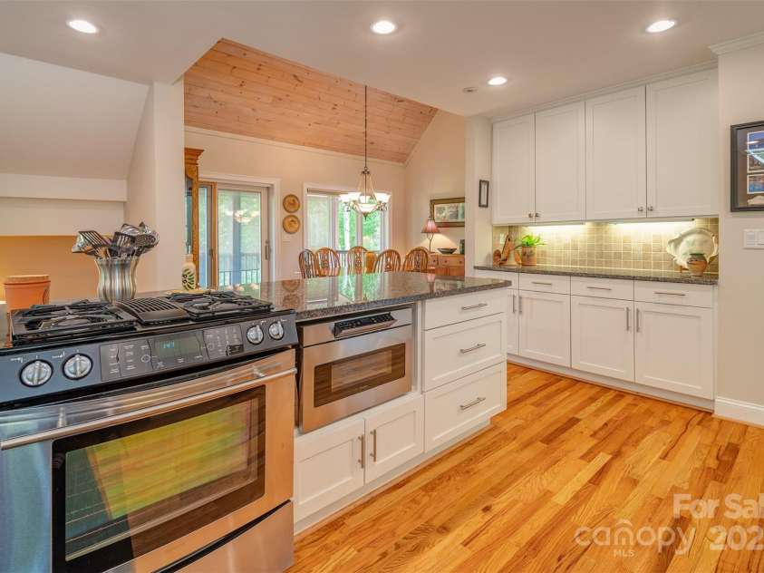 65 Hillcrest Drive, Weaverville, NC 28787.  MLS# CAR4275915, YatesRealty ID 23514. Gas range, maple cabinetry, hardwood floors, tile backsplash