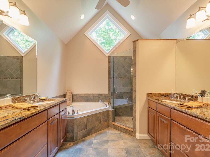 65 Hillcrest Drive, Weaverville, NC 28787.  MLS# CAR4275915, YatesRealty ID 23514. Gorgeous primary bathroom, separate vanities, jetted tub and shower