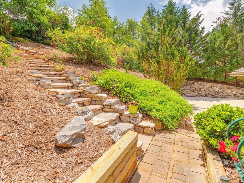 65 Hillcrest Drive, Weaverville, NC 28787.  MLS# CAR4275915, YatesRealty ID 23514. Landscape stone walkway up to adjacent High Bluff Drive (2 more pkg spaces)