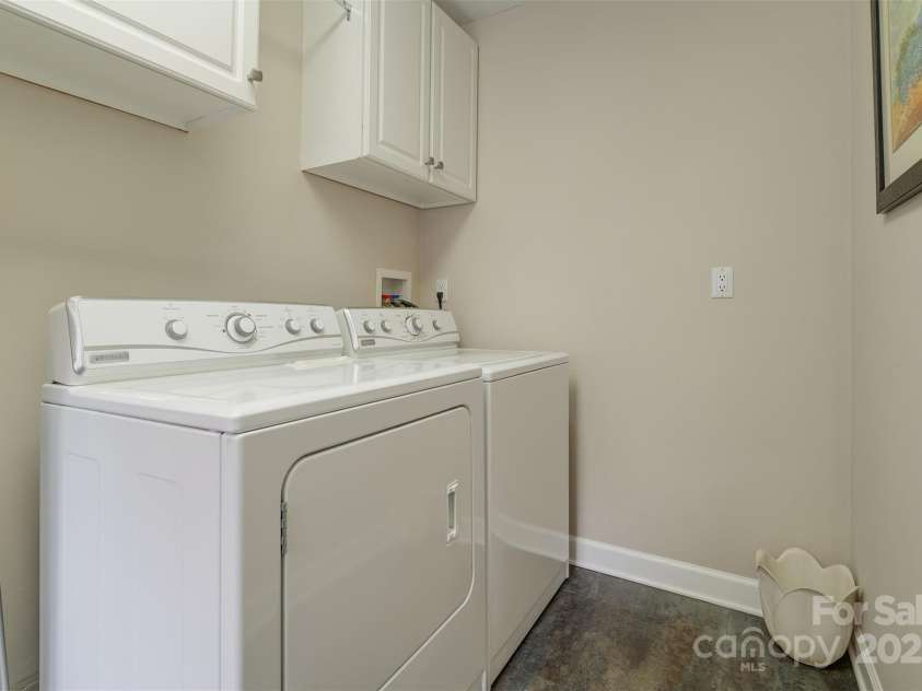 65 Hillcrest Drive, Weaverville, NC 28787.  MLS# CAR4275915, YatesRealty ID 23514. Laundry room sits between garage and kitchen with cabinetry and sink