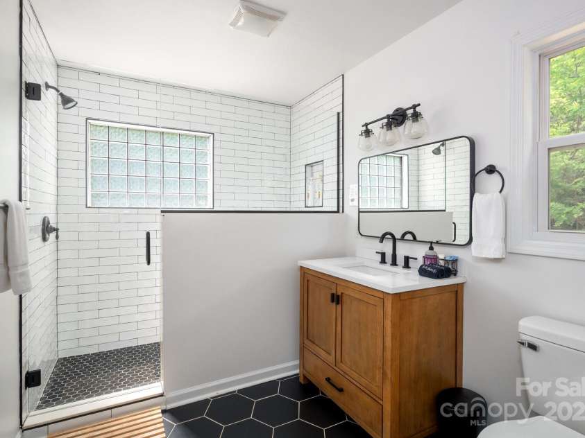 25 Licklog Ridge Road, Fairview, NC 28730.  MLS# CAR4256398, YatesRealty ID 23533. Primary Bath has Large Walk-in Tiled Shower