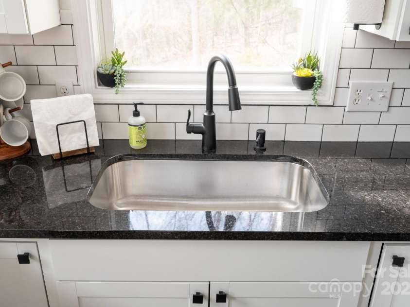 25 Licklog Ridge Road, Fairview, NC 28730.  MLS# CAR4256398, YatesRealty ID 23533. Stainless Sink, Granite Countertops and Subway Tile Backsplash