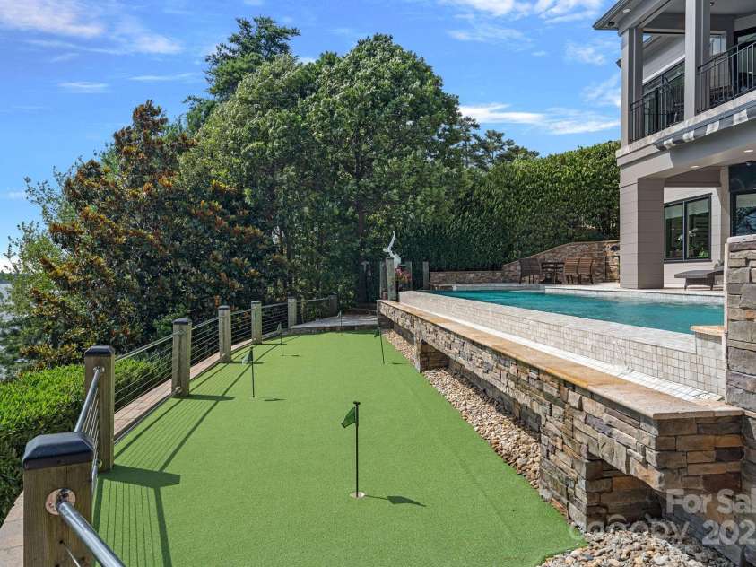 18007 Harbor Light Boulevard, Cornelius, NC 28031.  MLS# CAR4271847, YatesRealty ID 23544. Golf Everyday as you look at an Amazing Waterview or go inside to uses the Golf simulator.