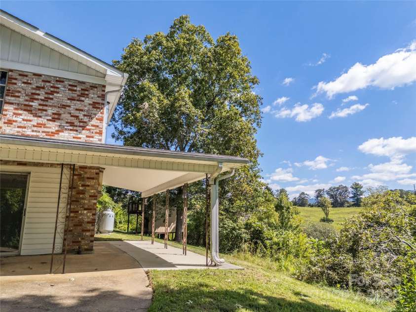 56 Gill Branch Road, Weaverville, NC 28787.  MLS# CAR4270678, YatesRealty ID 23563. Bottom entrance used to split the house with its own kitchen and bath setup.