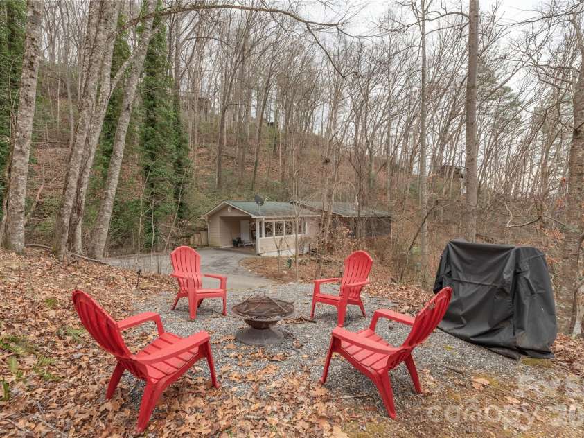 12 Bear Cove Lane, Bryson City, NC 28713.  MLS# CAR4337192, YatesRealty ID 2358. Directly across from the house is an elevated firepit and grill area.