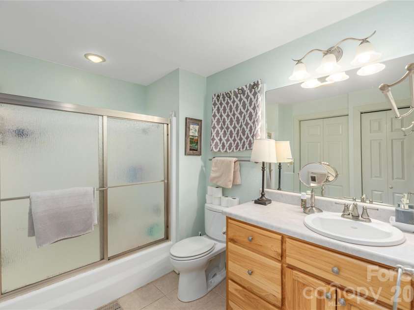 12 Bear Cove Lane, Bryson City, NC 28713.  MLS# CAR4337192, YatesRealty ID 2358. Ensuite bath with tub/shower and large natural wood vanity