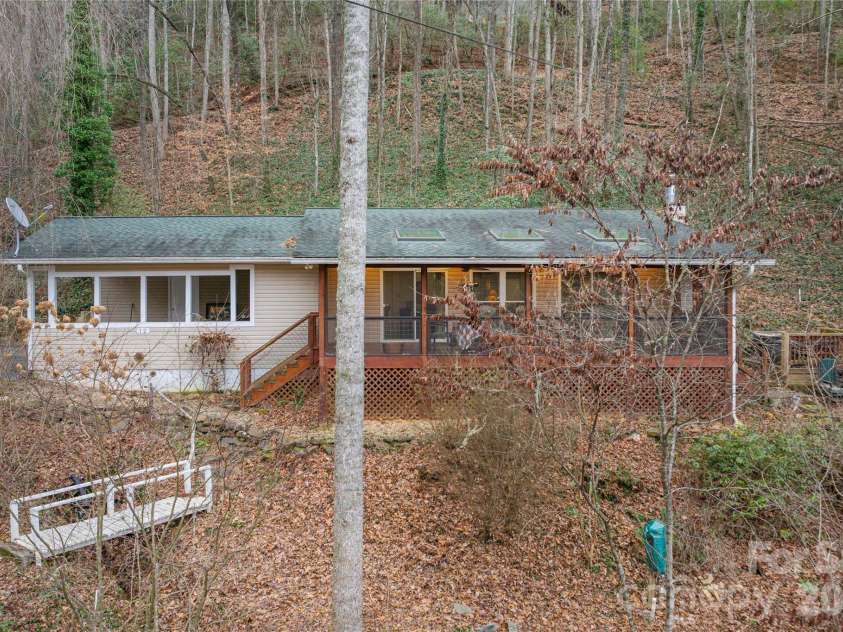 12 Bear Cove Lane, Bryson City, NC 28713.  MLS# CAR4337192, YatesRealty ID 2358. Front of home with bridge over your own babbling creek