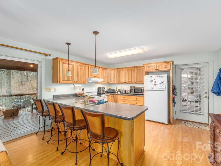 12 Bear Cove Lane, Bryson City, NC 28713.  MLS# CAR4337192, YatesRealty ID 2358. Kitchen features peninsula with overhead lighting and breakfast bar