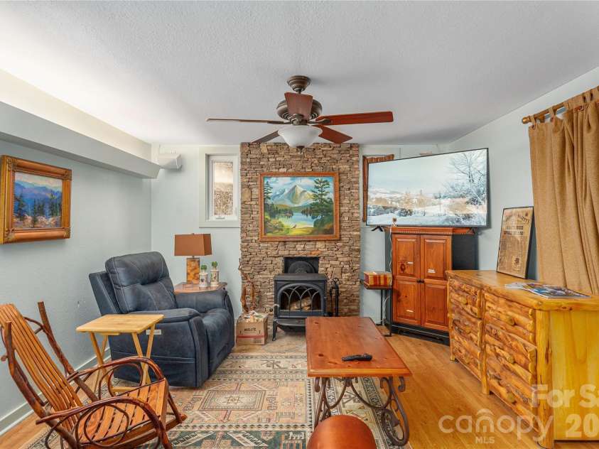 12 Bear Cove Lane, Bryson City, NC 28713.  MLS# CAR4337192, YatesRealty ID 2358. Living room features ceiling fan and luxury vinyl plank flooring