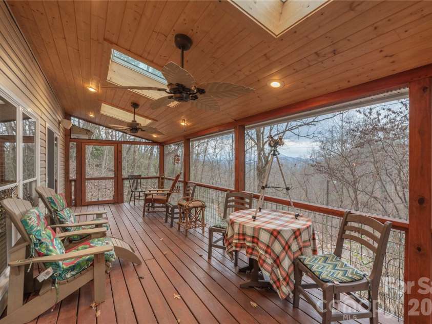 12 Bear Cove Lane, Bryson City, NC 28713.  MLS# CAR4337192, YatesRealty ID 2358. Screened covered front deck with two large skylights