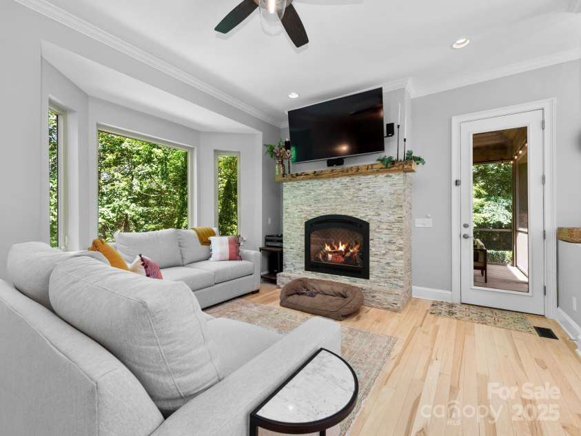 102 Gap Creek Road, Fletcher, NC 28732.  MLS# CAR4275624, YatesRealty ID 23580. Main Living Room w/ Tray Ceilings, Refinished Hardwood Floors, and Gas Glassed in Fireplace to Complement All The Natural Light.