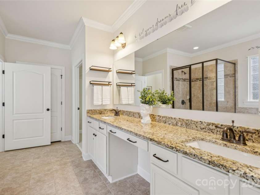 196 Hawks Creek Parkway, Fort Mill, SC 29708.  MLS# CAR4271545, YatesRealty ID 23591. Primary bath with granite countertops and vanity seating area