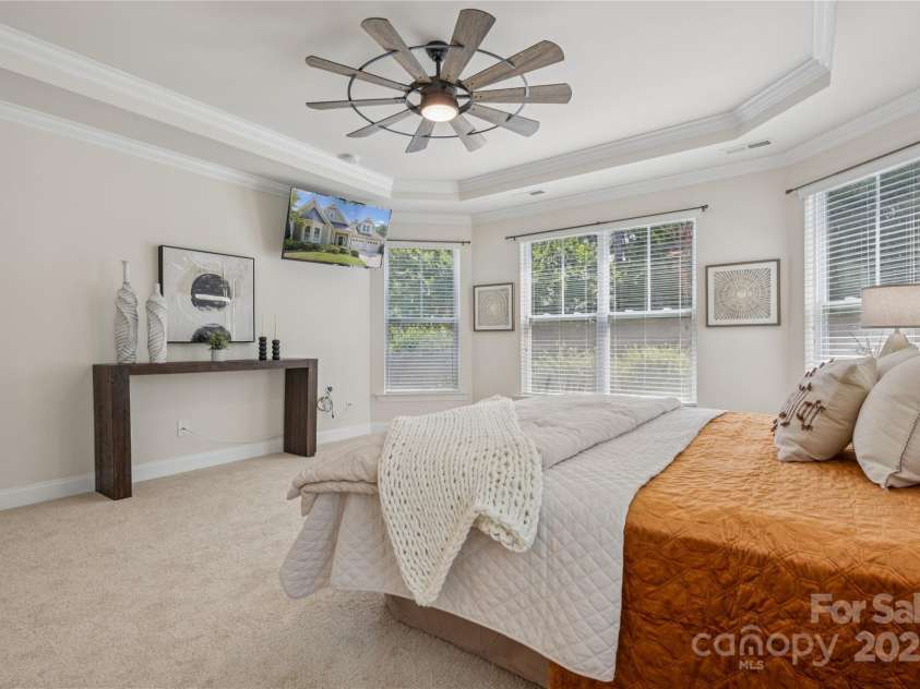 196 Hawks Creek Parkway, Fort Mill, SC 29708.  MLS# CAR4271545, YatesRealty ID 23591. Tray ceiling with ceiling fan accent the primary suite