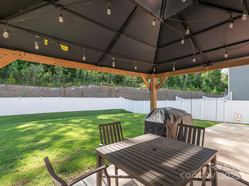 9123 Magnolia Lily Avenue, Charlotte, NC 28227.  MLS# CAR4272877, YatesRealty ID 23592. Backyard w/ pergola