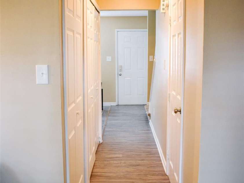 7526 Holly Grove Court, Charlotte, NC 28227.  MLS# CAR4269368, YatesRealty ID 23603. Hallway from the front to the back. Door on left leads to half bath and doorway to the right leads to the. laundry room.