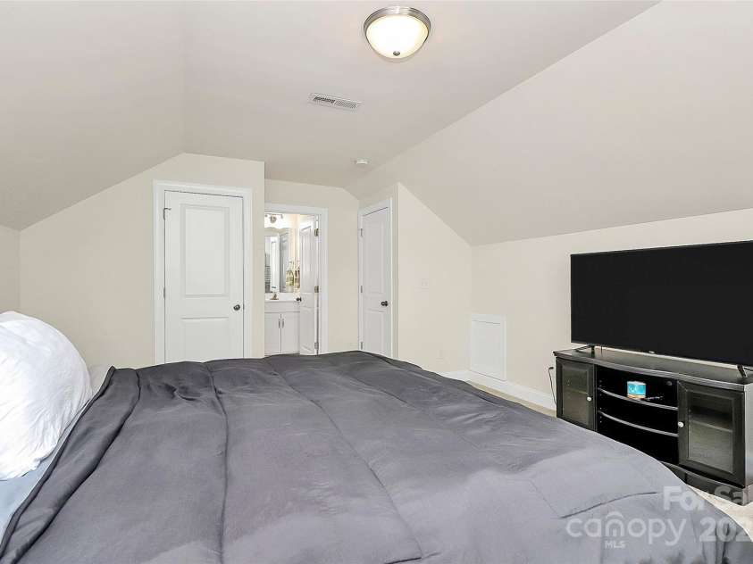 139 Suggs Mill Drive, Mooresville, NC 28115.  MLS# CAR4272116, YatesRealty ID 23610. Another view of the spacious third-floor bedroom/bonus room showcases a generous closet, an attached full bath, and convenient walk-in attic storage—offering flexibility and comfort all in one private retreat.
