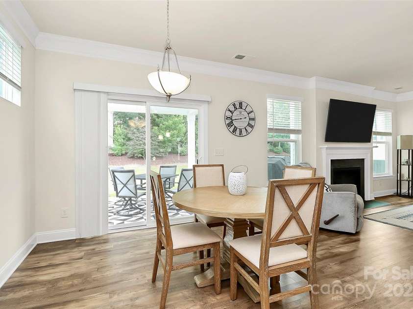 139 Suggs Mill Drive, Mooresville, NC 28115.  MLS# CAR4272116, YatesRealty ID 23610. Bright and cozy eat-in breakfast area featuring durable luxury vinyl plank flooring and sliding doors that open to a covered outdoor patio—perfect for enjoying your morning coffee or casual meals while soaking in fr