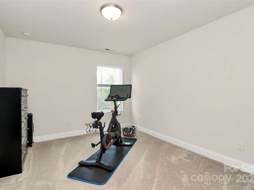 139 Suggs Mill Drive, Mooresville, NC 28115.  MLS# CAR4272116, YatesRealty ID 23610. Comfortable and bright, this secondary bedroom on the second floor offers ample space and natural light—perfect for guests, or a personalized retreat.