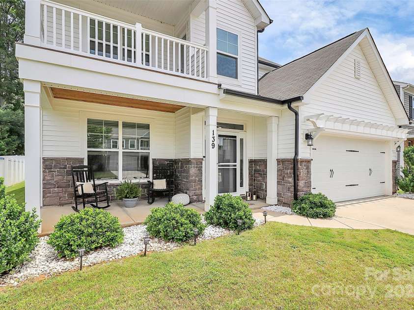 139 Suggs Mill Drive, Mooresville, NC 28115.  MLS# CAR4272116, YatesRealty ID 23610. Enjoy double the charm with this beautiful home featuring both a welcoming front porch and an upper-level front balcony.