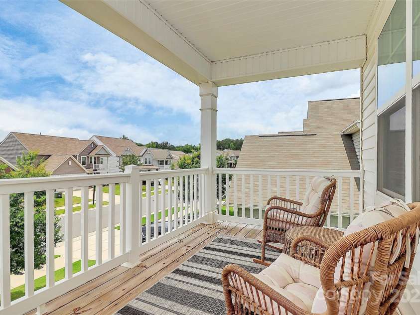 139 Suggs Mill Drive, Mooresville, NC 28115.  MLS# CAR4272116, YatesRealty ID 23610. Step out onto the second-story balcony and enjoy a peaceful outdoor retreat with charming views—perfect for morning coffee, evening relaxation, or simply soaking in the fresh air.