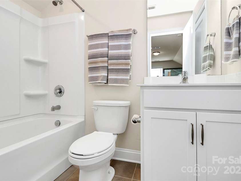 139 Suggs Mill Drive, Mooresville, NC 28115.  MLS# CAR4272116, YatesRealty ID 23610. The full bathroom on the third floor offers convenience and privacy, featuring modern fixtures and a clean design—perfect for guests or family members using the bonus space.