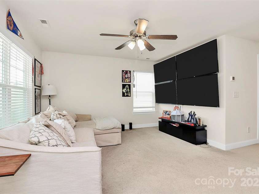 139 Suggs Mill Drive, Mooresville, NC 28115.  MLS# CAR4272116, YatesRealty ID 23610. This spacious loft area is fully outfitted with four TVs, making it the ultimate entertainment and gaming hub. Perfect for family fun or hosting friends, and the TVs can stay with the home if desired!