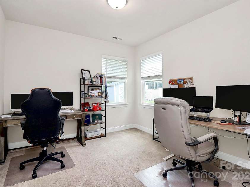 139 Suggs Mill Drive, Mooresville, NC 28115.  MLS# CAR4272116, YatesRealty ID 23610. This versatile main level bedroom is currently set up as a stylish home office, offering a quiet and functional space perfect for remote work, study, or guest accommodations.