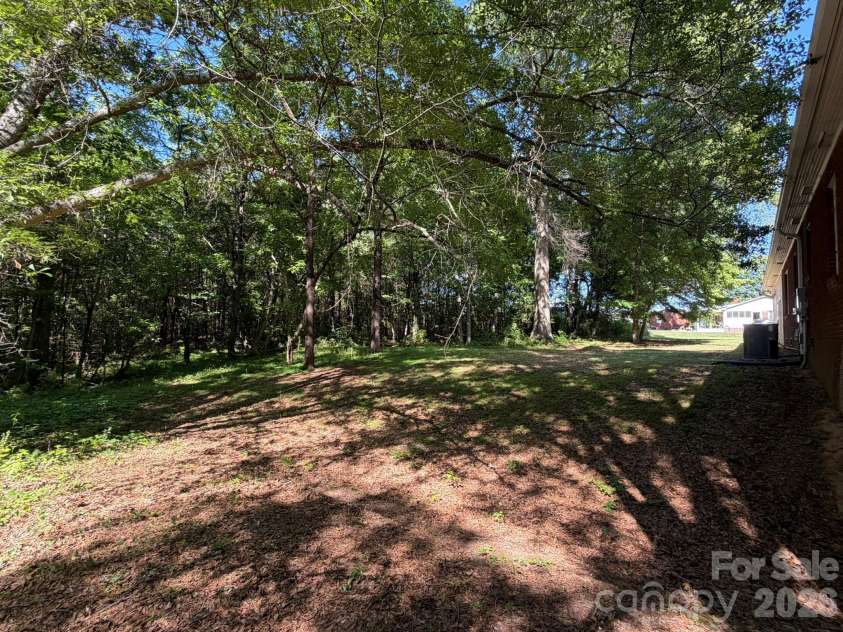 382 Alexis High Shoals Road, Dallas, NC 28034.  MLS# CAR4417122, YatesRealty ID 23613. Back yard view from left rear corner toward right