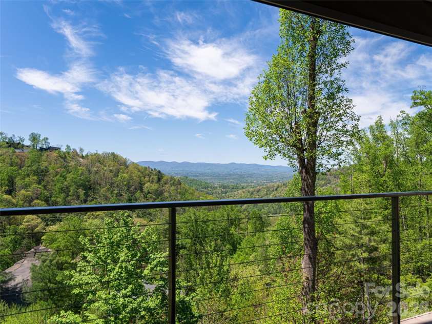 32 Timberwolf Court, Asheville, NC 28804.  MLS# CAR4376999, YatesRealty ID 23625. See through cable railings allow for unobstructed views from deck