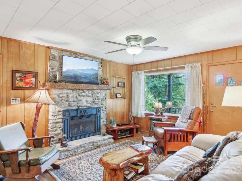 51 Atari Road, Waynesville, NC 28786.  MLS# CAR4256064, YatesRealty ID 23630. Cozy Living room with warmth and entertainment