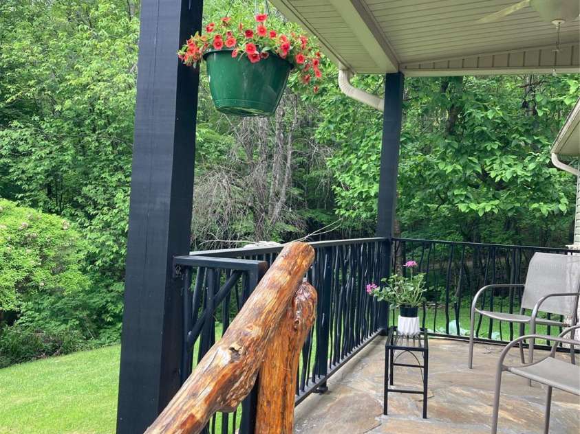 51 Atari Road, Waynesville, NC 28786.  MLS# CAR4256064, YatesRealty ID 23630. Hand carved railing lovingly lacquered to perfection and protection