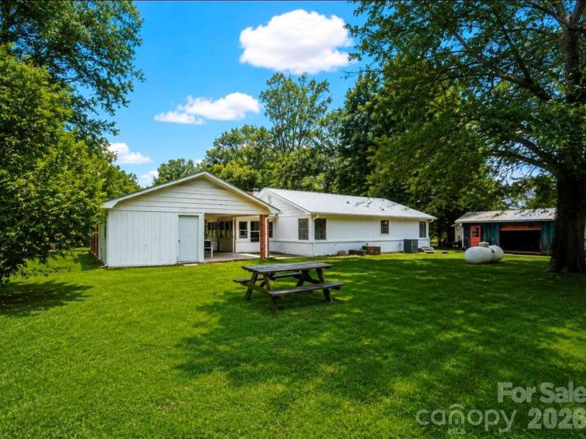109 Wall Road, Tryon, NC 28782.  MLS# CAR4326151, YatesRealty ID 23634. Back of home - on Pacolet River and NEVER FLOODED!!