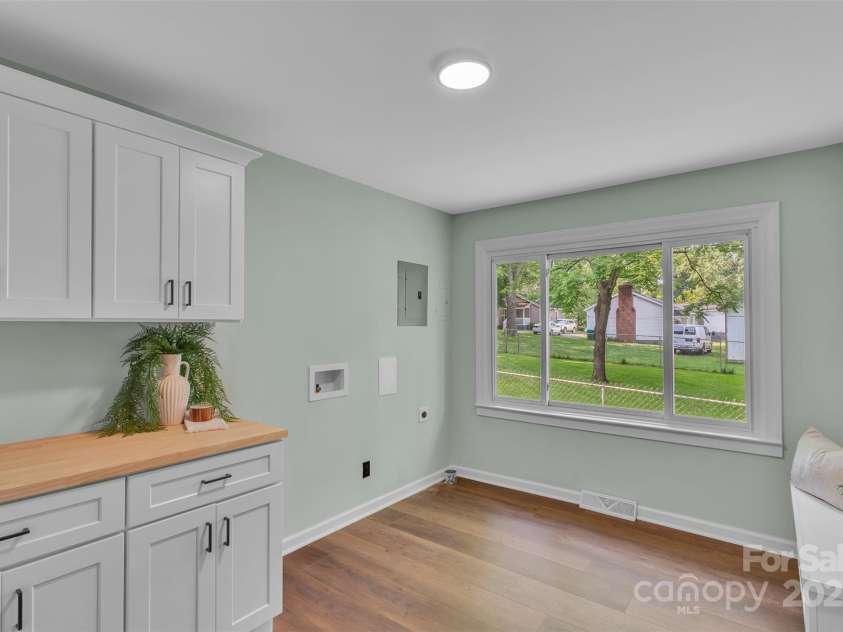506 Maine Avenue, Bessemer City, NC 28016.  MLS# CAR4077822, YatesRealty ID 23636. Say goodbye to clutter! This laundry room features built-in cabinets for effortless organization and a custom drop zone that keeps bags, shoes, and coats in check—making coming home feel put together and stress-free.