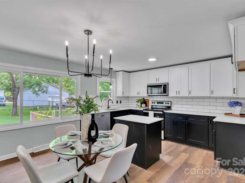 506 Maine Avenue, Bessemer City, NC 28016.  MLS# CAR4077822, YatesRealty ID 23636. The heart of the home is ready for your next dinner or quiet coffee morning. This airy, open-concept kitchen offers generous counter space, crisp black and white cabinetry, stainless steel appliances, and a layout tha