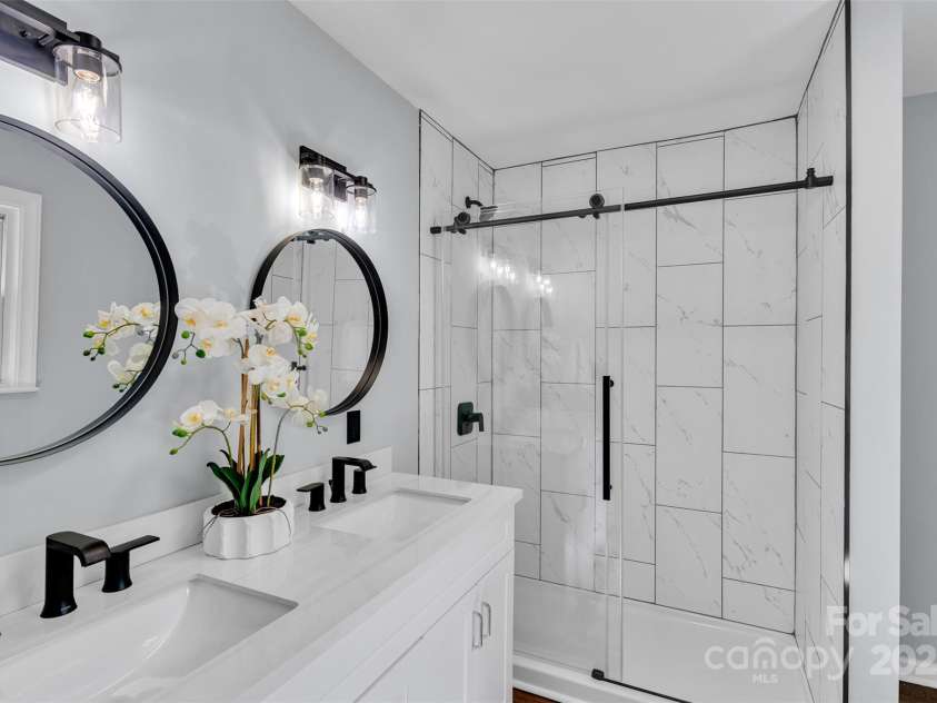 506 Maine Avenue, Bessemer City, NC 28016.  MLS# CAR4077822, YatesRealty ID 23636. The luxurious primary bathroom features a dual vanity with sleek finishes—giving everyone their own space during busy mornings.  Sophisticated, spacious, and serene.