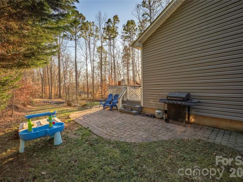 107 Barndale Drive, Troutman, NC 28166.  MLS# CAR4340490, YatesRealty ID 2366. Paver patio wraps to the side of the house