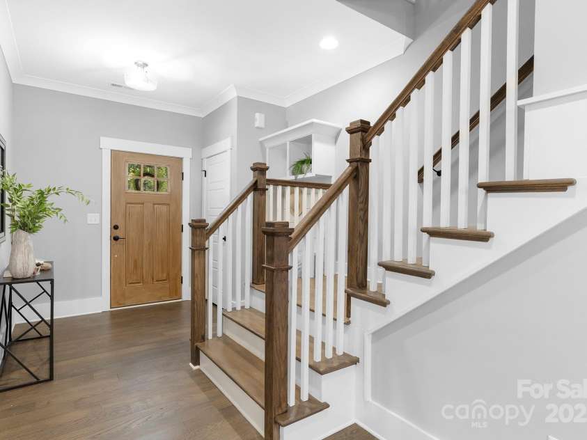 2517 Marlowe Avenue, Charlotte, NC 28208.  MLS# CAR4263015, YatesRealty ID 23670. Dark hardwoods, custom crown and baseboard detailing, and an elegant, timeless staircase set the tone for a home that blends sophistication with classic charm—a winning combination from the very first step inside.”