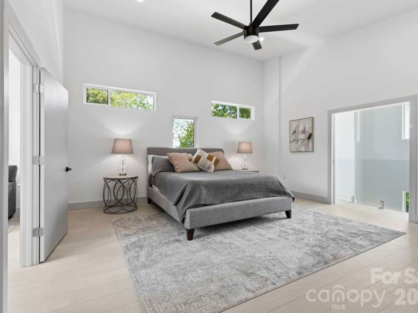 22 Lara Drive, Mills River, NC 28759.  MLS# CAR4382358, YatesRealty ID 23687. Spacious primary suite with vaulted ceilings, designer lighting, expansive layout, and serene modern styling.