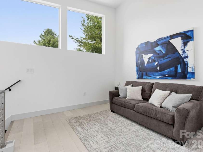 22 Lara Drive, Mills River, NC 28759.  MLS# CAR4382358, YatesRealty ID 23687. Upper-level loft or flex space with soaring ceilings, oversized windows, and abundant natural light.