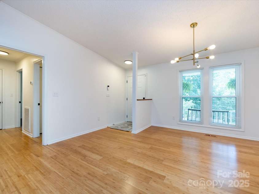 7960 Tiburon Circle, Charlotte, NC 28215.  MLS# CAR4276761, YatesRealty ID 23690. Dining area leading into guest bedroom/bath hallway.