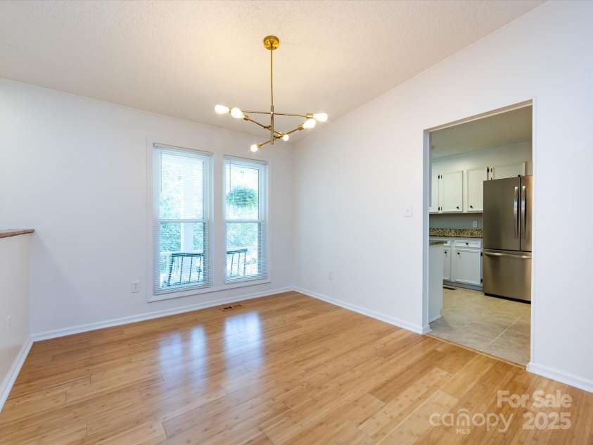 7960 Tiburon Circle, Charlotte, NC 28215.  MLS# CAR4276761, YatesRealty ID 23690. Dining area with updated light fixture.