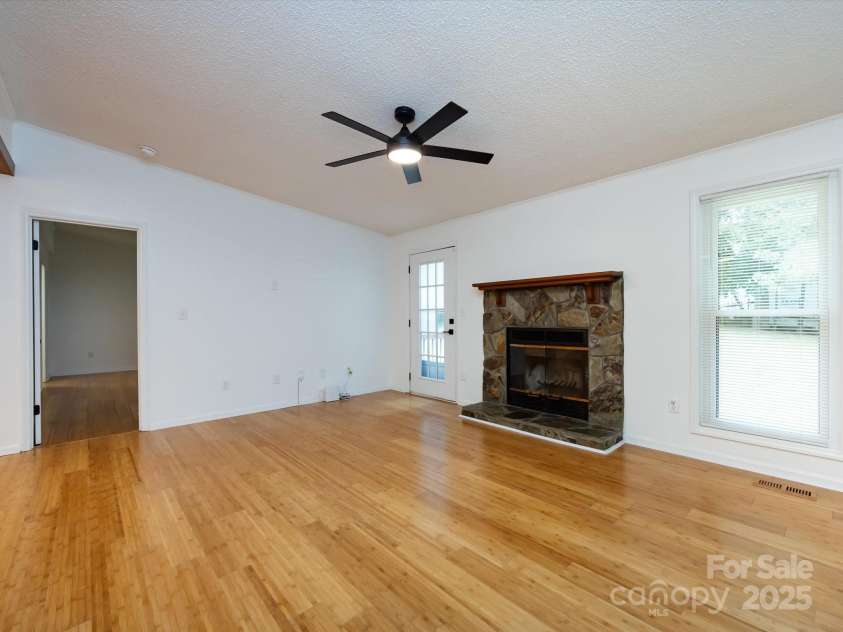 7960 Tiburon Circle, Charlotte, NC 28215.  MLS# CAR4276761, YatesRealty ID 23690. Family room leading into the primary bedroom.