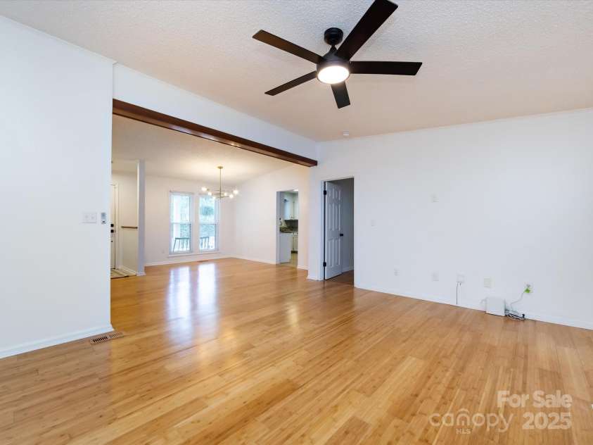 7960 Tiburon Circle, Charlotte, NC 28215.  MLS# CAR4276761, YatesRealty ID 23690. Family room looking into dining area.